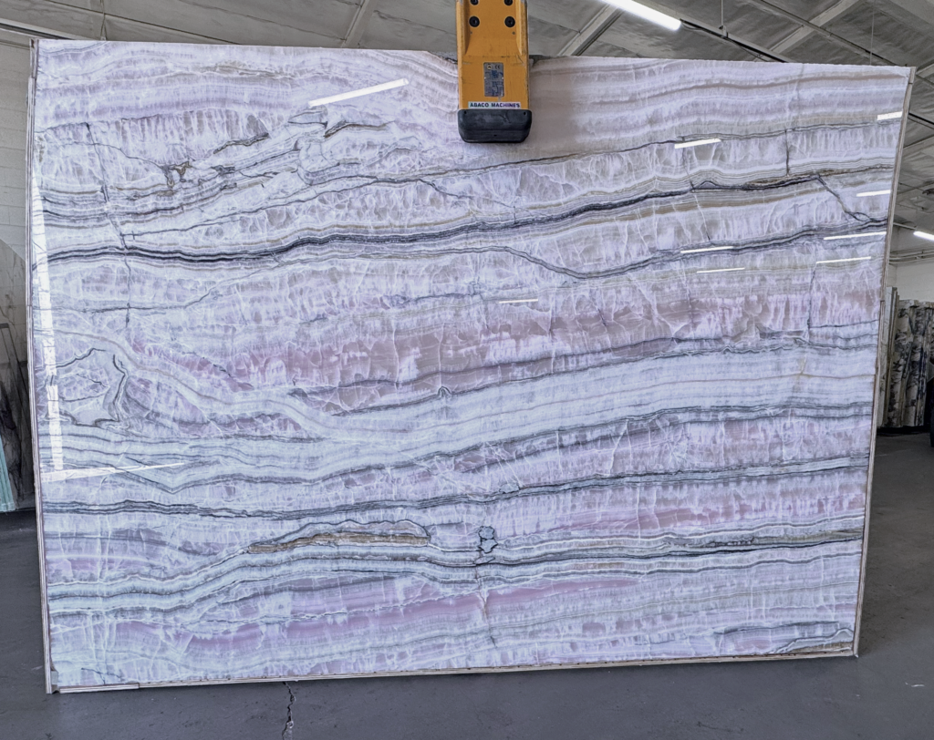 Chanel Onyx slab with layered pink, lavender, white and grey veining, available from The World of Stone in Los Angeles.