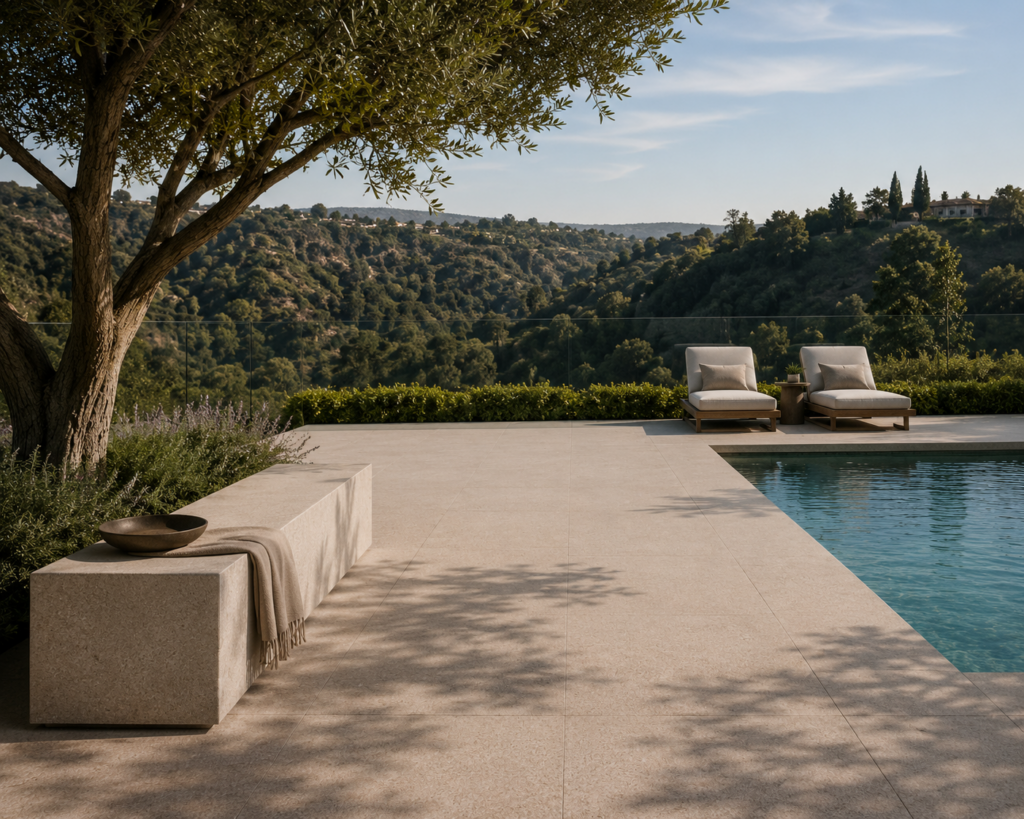 Luxury pool deck featuring Gascogne Beige Velvet limestone with a sandblasted and brushed finish overlooking a scenic hillside.