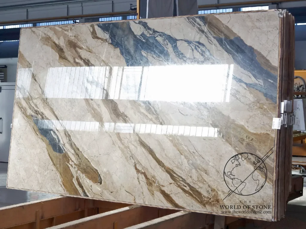 Polished Breccia Fantastica marble slab from Italy featuring dramatic blue, gray, gold, and cream veining displayed in The World of Stone slab gallery.