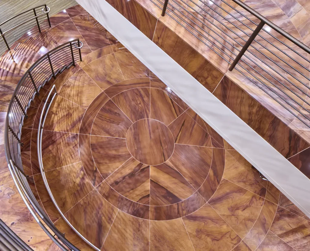 Custom circular floor inlay crafted from Desert Blend Meta Quartzite in a commercial building featuring precision stone fabrication and architectural detailing.