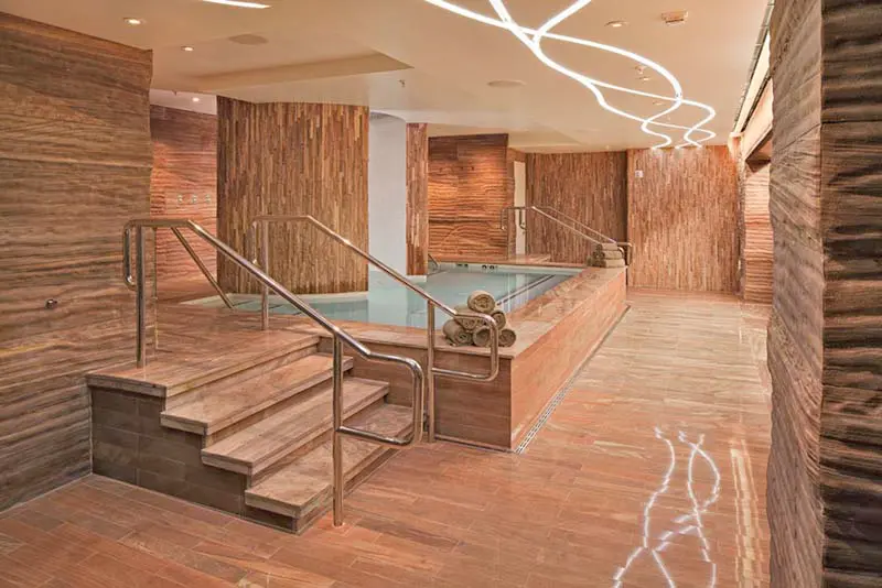 Luxury spa interior featuring Desert Blend Meta Quartzite on floors, walls, stairs, and architectural surfaces in a high-end hospitality environment.