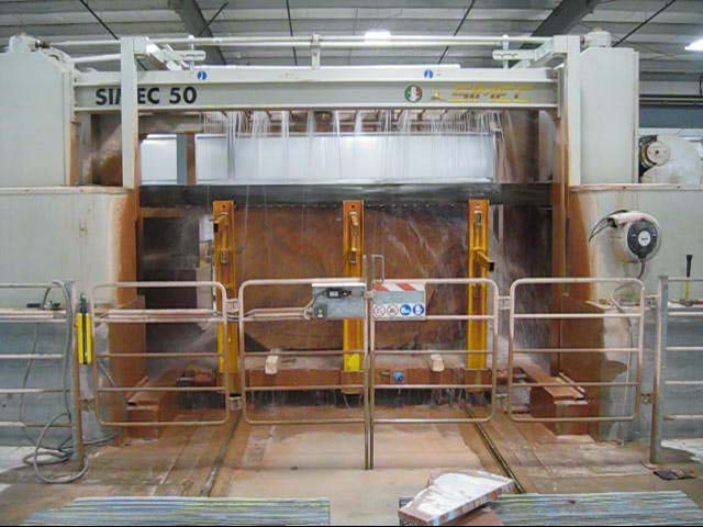 Gang saw cutting a Sierra Smoke Meta Quartzite block into slabs at the Las Vegas Rock fabrication facility.