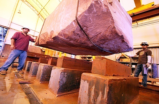 Large Sierra Smoke Meta Quartzite block being positioned for inspection and processing before slab production.