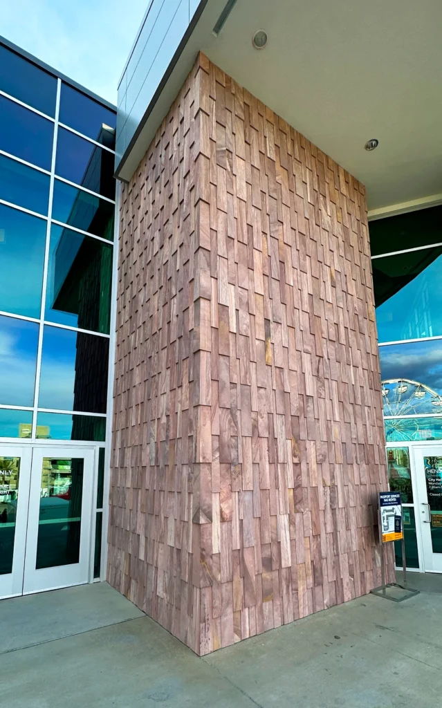 Commercial building entrance featuring Sierra Smoke Meta Quartzite dimensional stone cladding on an architectural exterior wall.