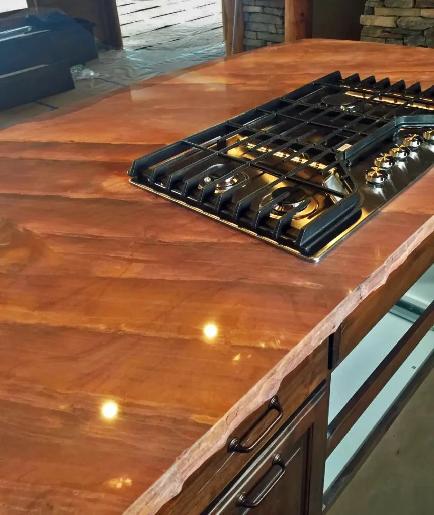 Sierra Smoke Meta Quartzite live-edge kitchen countertop with integrated gas cooktop in a custom luxury residence.