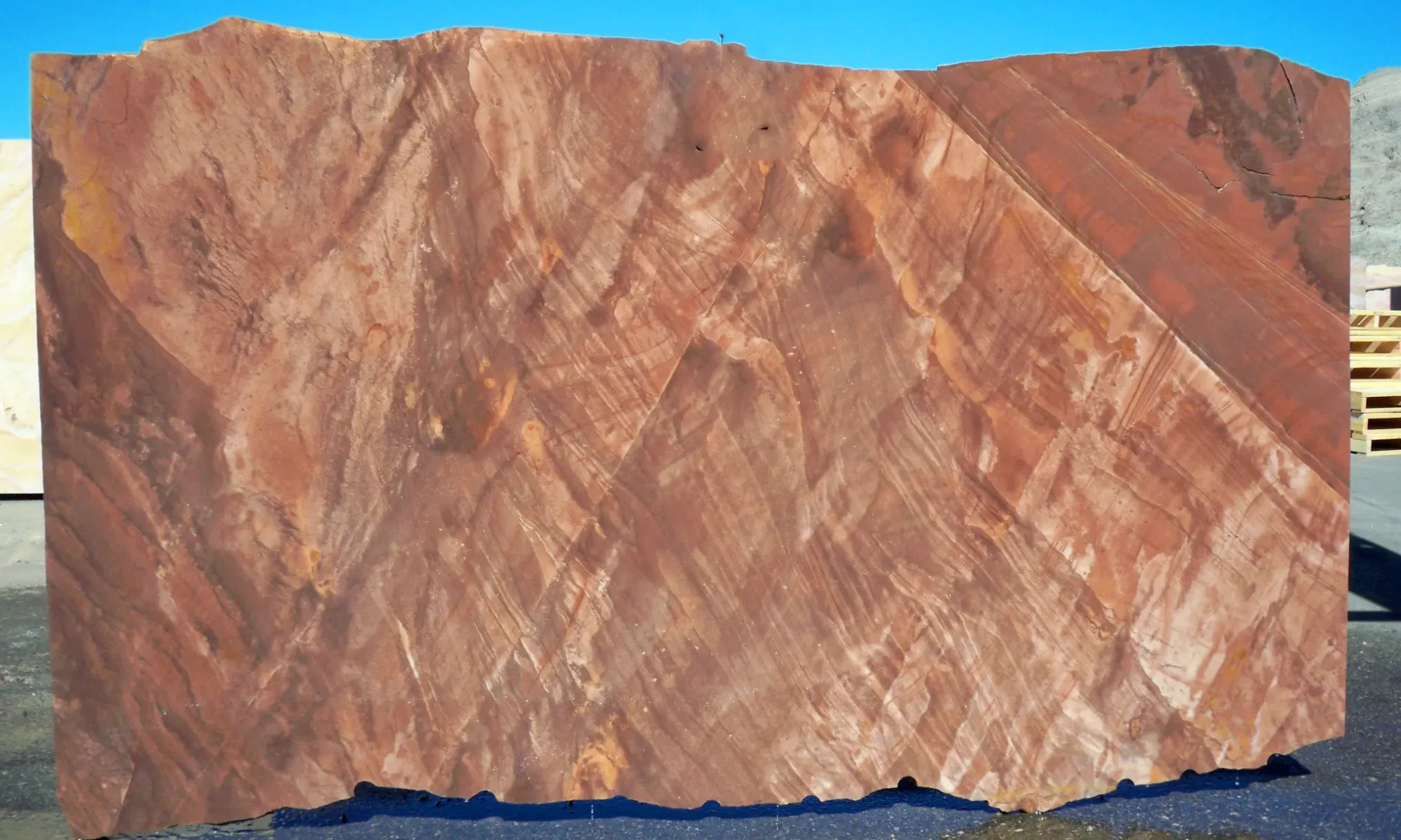 Full slab of Sierra Smoke Meta Quartzite featuring smoky gray, taupe, cocoa, and charcoal tones with bold diagonal movement and natural veining.