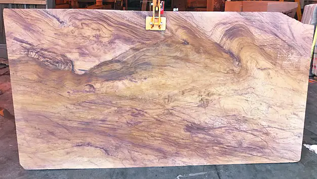 Polished Tupelo Honey® Meta Quartzite slab featuring flowing gold, cream, lavender, and plum veining from the Rainbow Quarry in Goodsprings, Nevada.