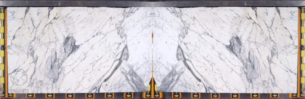 Bookmatched Arabescato Corchia marble slabs with dramatic gray veining across a creamy white background.