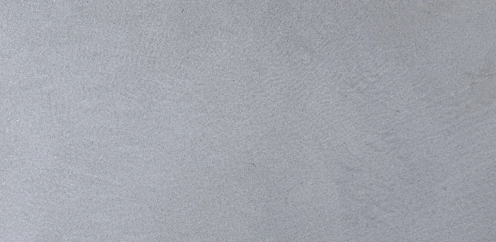 Close-up of Pietra Serena sandstone showing its fine, uniform grain and characteristic blue-gray color.