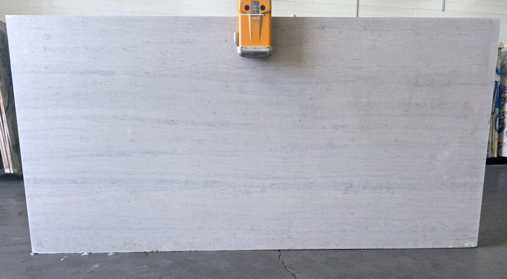 Ataija Blue Storm vein-cut limestone slab with soft blue-gray coloring and subtle linear movement.