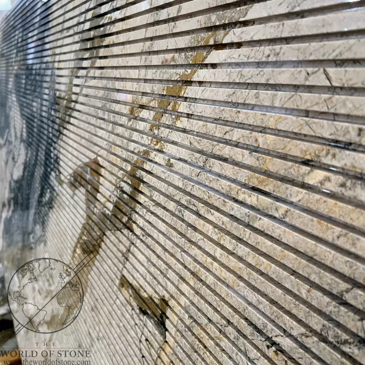 Angled view of Breccia Fantastica Italian marble slab showing deep horizontal grooves and dramatic black, cream, and gold veining.
